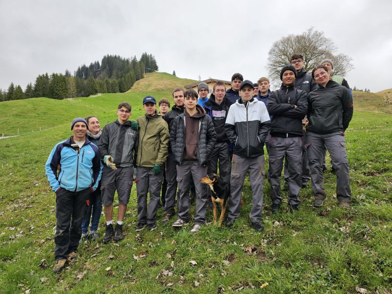Die Freiwilligengruppe (Lernende) der Reishauer AG mit den Alpbewirtschaftern (Nutzniessern) Michael Oesch und Bettina Brunner (links).